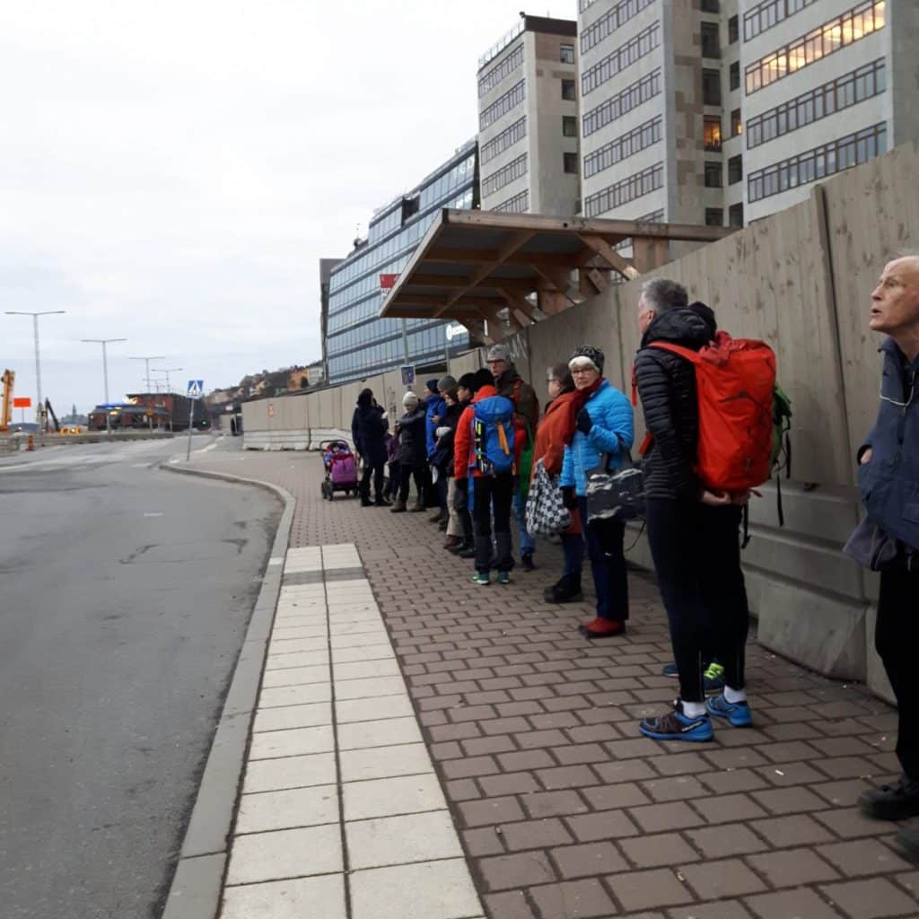 Swedes standing in line at the bus stop